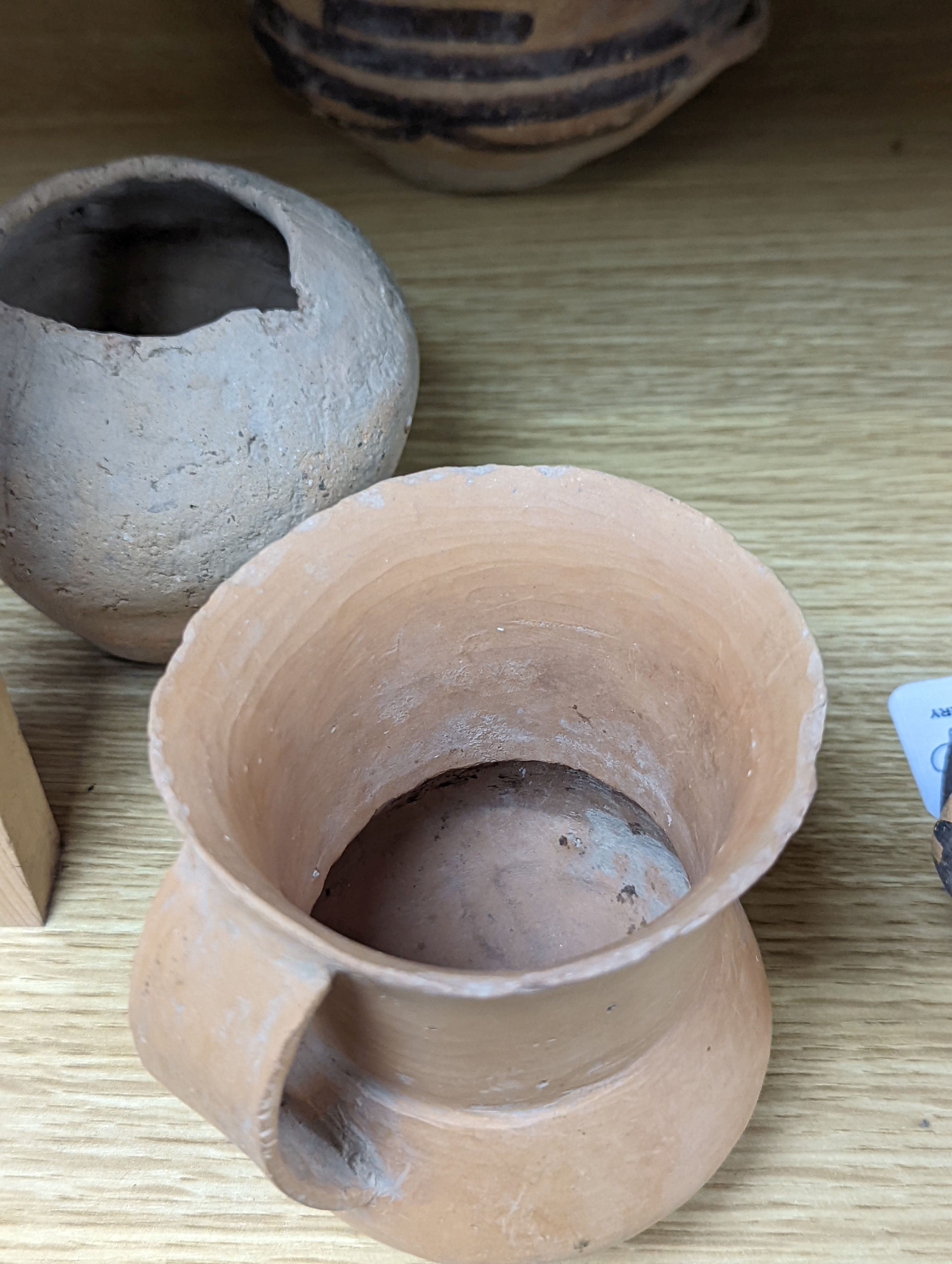 Four Chinese Neolithic pottery vessels, 11cm